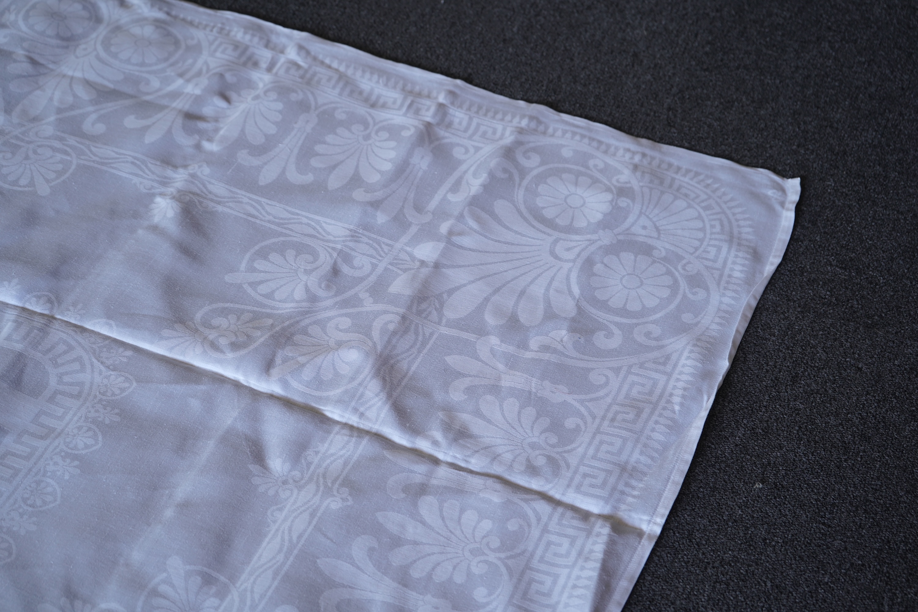 A late 19th century large white Irish damask table cloth, woven with an all over Christopher Dresser ‘inspired’ design. The overall design incorporating many of his known stylistic design motifs. Each corner has a shamro